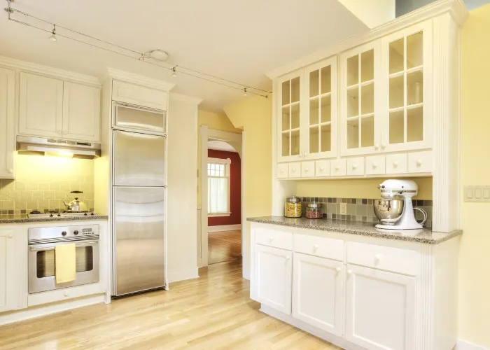 Newly remodeled kitchen with white kitchen cabinets and granite countertops