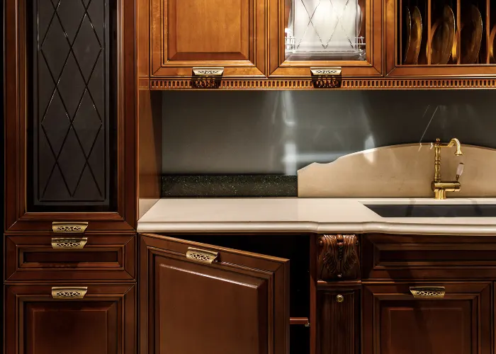 Beautiful dark wood kitchen cabinets with brass ornamental handles